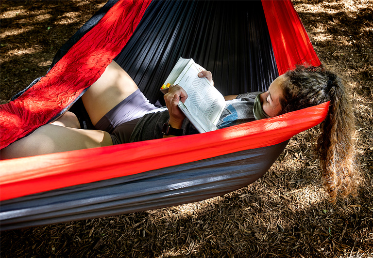 Student lounging in hammock